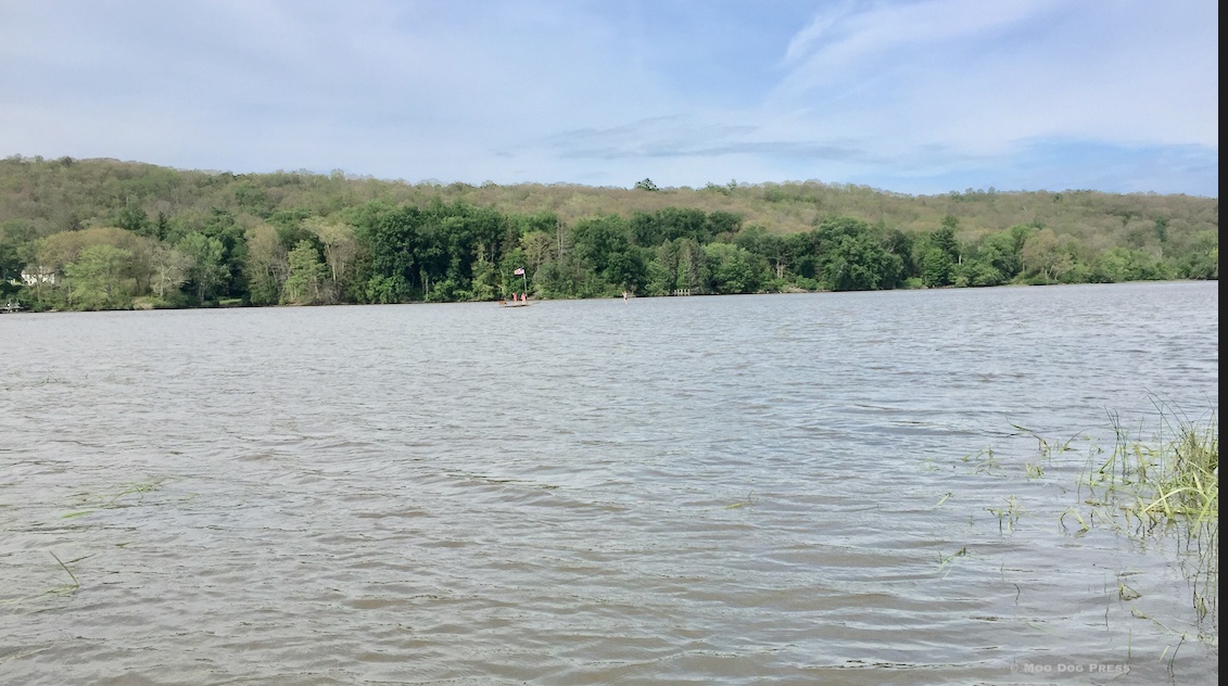 The long, tidal Connecticut River and a flag with people seen. In every season, discoveries may be made along the river.