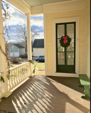 Veranda of the Stevens-Frisbie House and the barn beyond. © Moo Dog Press